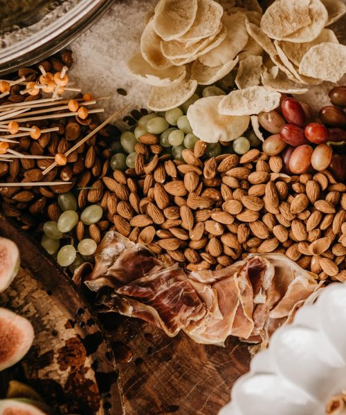 overhead-shot-table-full-almonds-prosciutto-figs-dry-fruit (1)-min